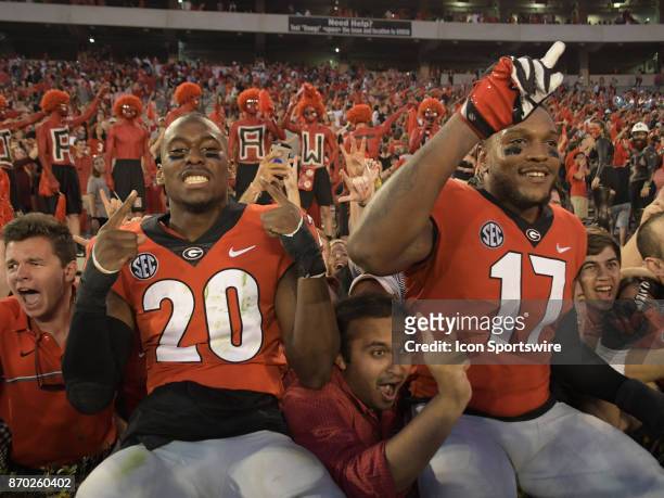 Victorious Georgia Bulldogs defensive back J.R. Reed and Georgia Bulldogs linebacker Davin Bellamy celebrate after the game between the South...