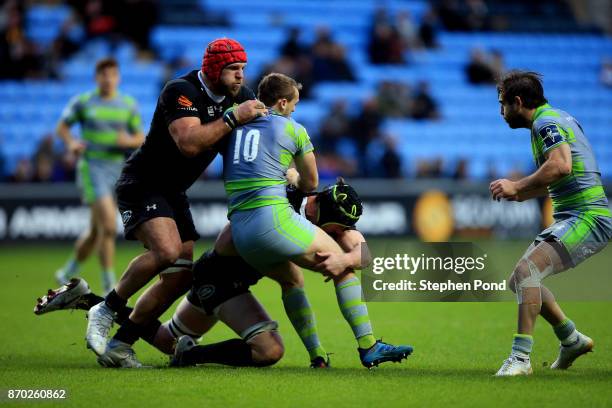 Craig Willis of Newcastle is tackled by James Gaskell of Wasps during the Anglo-Welsh Cup match between Wasps and Newcastle Falcons at Ricoh Arena on...