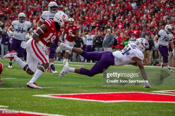 Northwestern Wildcat running back Justin Jackson dives across the goal line for a touchdown against the Nebraska Cornhuskers in the first quarter...