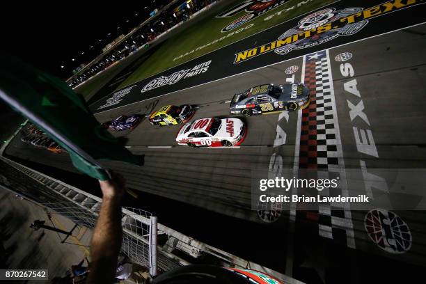 Erik Jones, driver of the GameStop/Call of Duty WWII Toyota, leads Cole Custer, driver of the Haas Automation Ford, and Matt Tifft, driver of the...