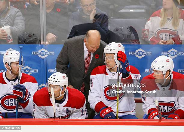 Head Coach Claude Julien of the Montreal Canadiens instructs Charles Hudon on the bench during second period action against the Winnipeg Jets at the...