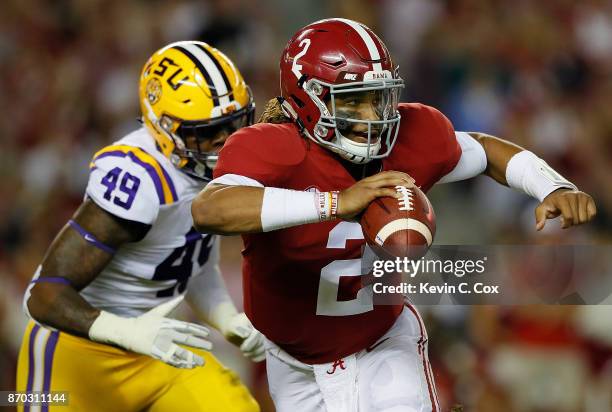 Jalen Hurts of the Alabama Crimson Tide rushes away from Arden Key of the LSU Tigers at Bryant-Denny Stadium on November 4, 2017 in Tuscaloosa,...