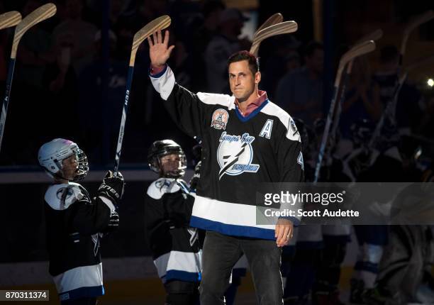 Vincent Lecavalier waves to fans as the Tampa Bay Lightning honor the 2004 Stanley Cup Champions as part of their 25th anniversary celebration before...