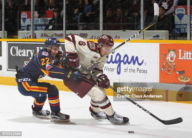 Luke Bignell of the Barrie Colts skates to check Austin Osmanski of the Peterborough Petes during an OHL game at the Peterborough Memorial Centre on...