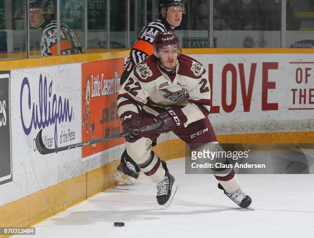 Chad Denault of the Peterborough Petes skates with the puck against the Barrie Colts during an OHL game at the Peterborough Memorial Centre on...