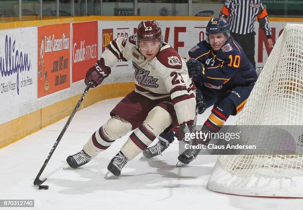 Justin Murray of the Barrie Colts tries to contain Matyas Svoboda of the Peterborough Petes during an OHL game at the Peterborough Memorial Centre on...
