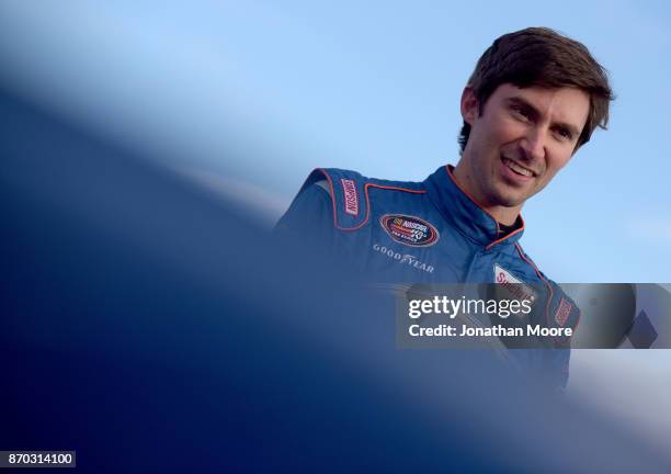 Michael Self, driver of the Sunrise Ford/Eibach Springs/Lucas Oil Ford, stands next to his car during qualifying for the NASCAR K&N Pro Series West...