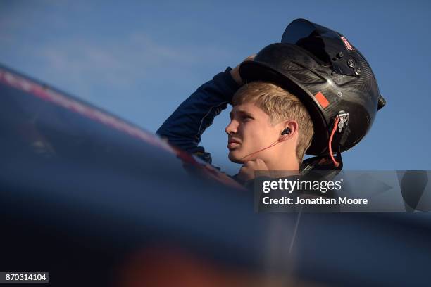 Derek Kraus, driver of the Carlyle Tools Toyota, stands next to his car during qualifying for the NASCAR K&N Pro Series West Coast Stock Car Hall of...