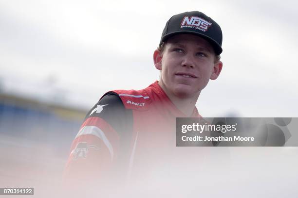 Riley Herbst, driver of the Terrible Herbst Toyota, stands next to his car during qualifying for the NASCAR K&N Pro Series West Coast Stock Car Hall...