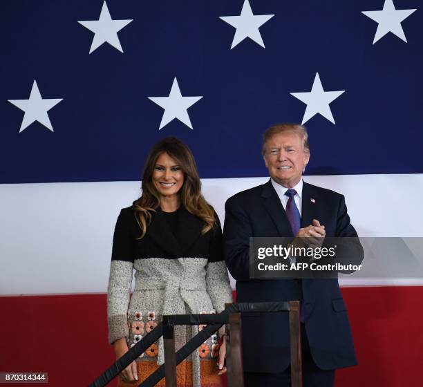 President Donald Trump and First Lady Melania smile upon arriving at US Yokota Air Base in Tokyo on November 5, 2017. Trump touched down in Japan,...