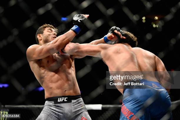 Johny Hendricks lands a punch against Paulo Costa of Brazil in their middleweight bout during the UFC 217 event at Madison Square Garden on November...