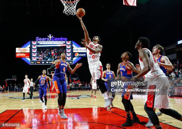 Jarell Eddie of the Windy City Bulls goes to the basket against Isaiah Hicks and Xavier Rathan-Mayes of the Westchester Knicks during the first half...