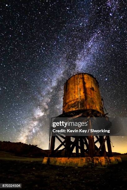 milky water: milky way and old railroad water tower - train yard at night stock pictures, royalty-free photos & images