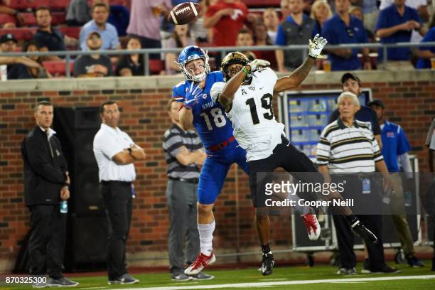 Mike Hughes of the UCF Knights tips the ball away from Trey Quinn of the SMU Mustangs during the second half at Gerald J. Ford Stadium on November 4,...