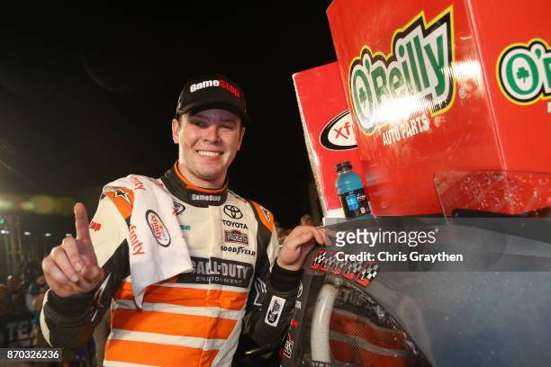 Erik Jones, driver of the GameStop/Call of Duty WWII Toyota, poses with the winner's decal in Victory Lane after winning the NASCAR XFINITY Series...