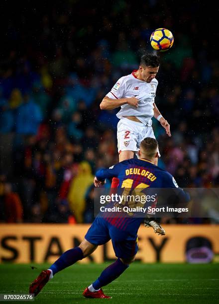 Gerard Deulofeu of Barcelona competes for the ball with Sebastien Corchia of Sevilla during the La Liga match between Barcelona and Sevilla at Camp...