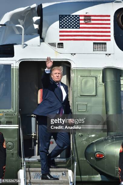 President Donald Trump waves as he boards a helicopter at Yokota Air Base in Tokyo, Japan on November 05, 2017.