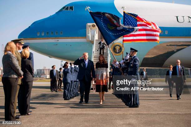 President Donald Trump and First Lady Melania Trump walk through an honour cordon as they arrive at Yokota Air Base at Fussa in Tokyo on November 5,...
