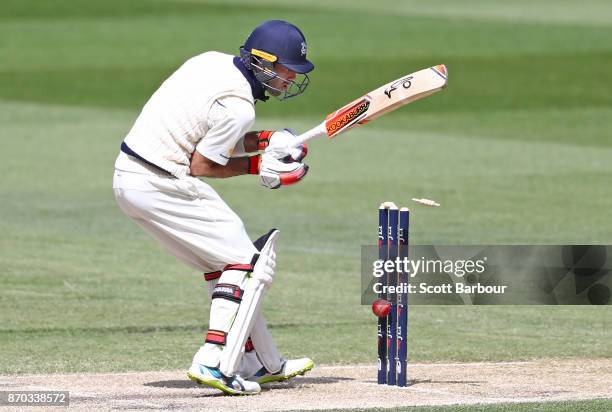 Glenn Maxwell of Victoria watches as the ball hits the stumps and he is dismissed during day two of the Sheffield Shield match between Victoria and...