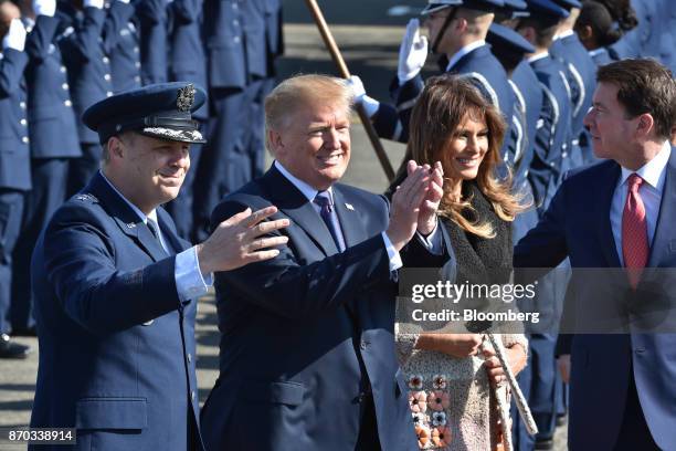 President Donald Trump, second left, applauds as he arrives with U.S. First Lady Melania Trump, second right, at U.S. Yokota Air Base in Fussa, Tokyo...