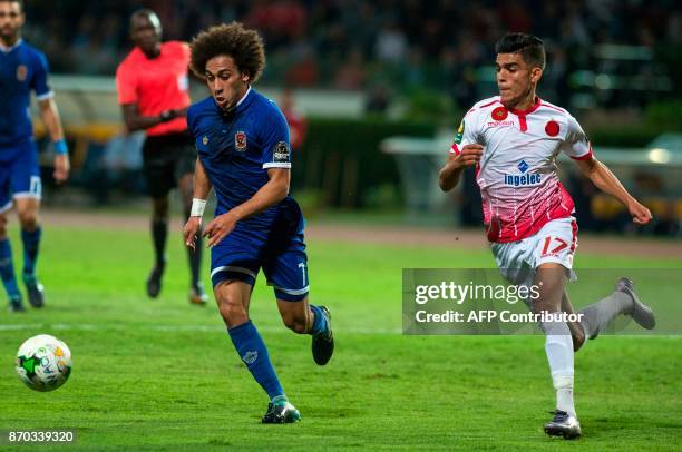 Wydad Casablanca's Achraf Bencharki vies for the ball against Al-Ahly's Sherif Ekramy Ahmed during the CAF Champions League final football match...