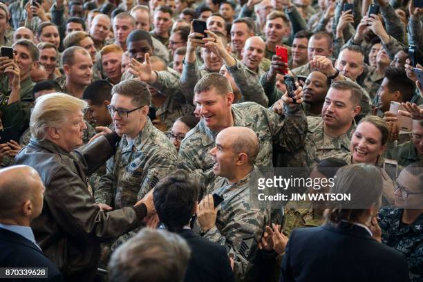 President Donald Trump greets US troops after speaking during an event with US military personnel at Yokota Air Base at Fussa in Tokyo on November 5,...