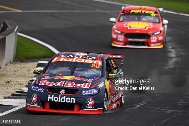 Jamie Whincup drives the Red Bull Holden Racing Team Holden Commodore VF leads Scott McLaughlin drives the Shell V-Power Racing Team Ford Falcon FGX...