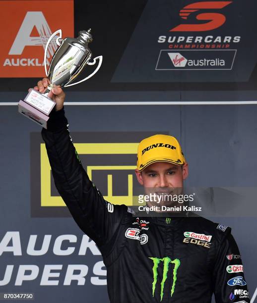 3rd place Cameron Waters driver of the Monster Energy Ford Falcon FGX celebrates on the podium after race 24 for the Auckland SuperSprint, which is...