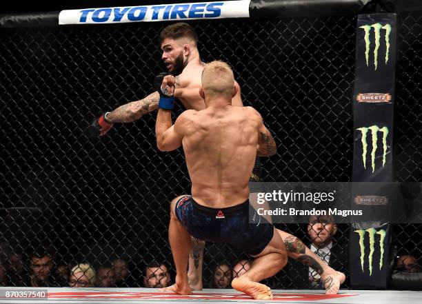 Cody Garbrandt knocks down TJ Dillashaw in their UFC bantamweight championship bout during the UFC 217 event inside Madison Square Garden on November...