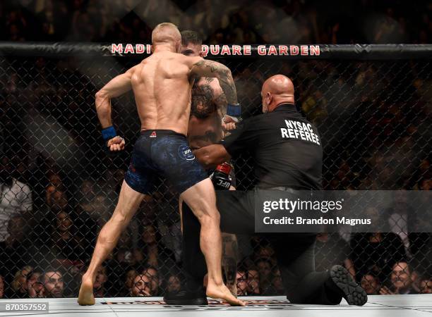 Dillashaw celebrates his knockout victory over Cody Garbrandt in their UFC bantamweight championship bout during the UFC 217 event inside Madison...