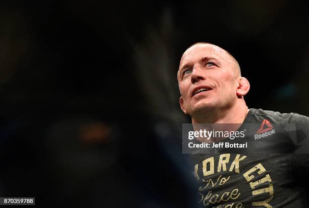 Georges St-Pierre of Canada smiles after defeating Michael Bisping of England in their UFC middleweight championship bout during the UFC 217 event at...