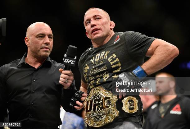 Georges St-Pierre of Canada accepts his championship belt after defeating Michael Bisping of England in their UFC middleweight championship bout...
