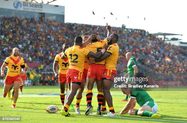 Garry Lo of Papua New Guinea is congratulated by team mates after scoring a try during the 2017 Rugby League World Cup match between Papua New Guinea...