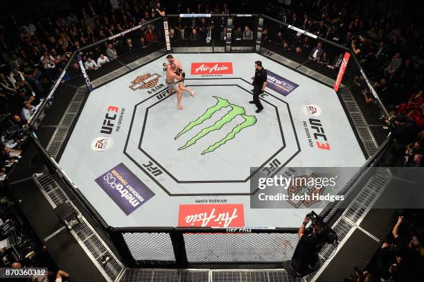 Georges St-Pierre of Canada fights Michael Bisping of England in their UFC middleweight championship bout during the UFC 217 event at Madison Square...