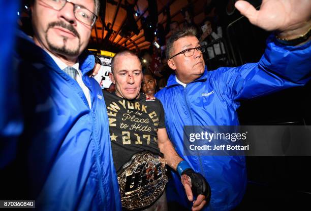 Georges St-Pierre of Canada exits the octagon after defeating Michael Bisping of England in their UFC middleweight championship bout during the UFC...