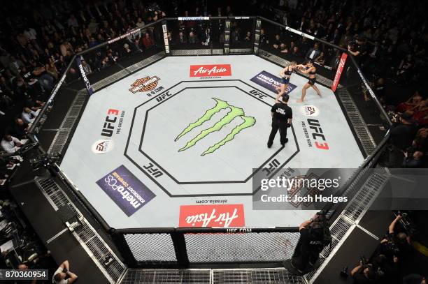 Rose Namajunas lands a punch against Joanna Jedrzejczyk of Poland in their UFC women's strawweight championship bout during the UFC 217 event at...