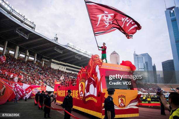 Zeng Cheng of Guangzhou Evergrande waves a flag during the Champion Award Ceremony for 2017 Chinese Football Association Super League on November 4,...