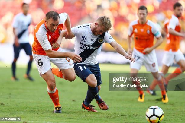 Avram Papadopoulos of the Roar and Connor Pain of the Glory compete for the ball during the round five A-League match between the Brisbane Roar and...