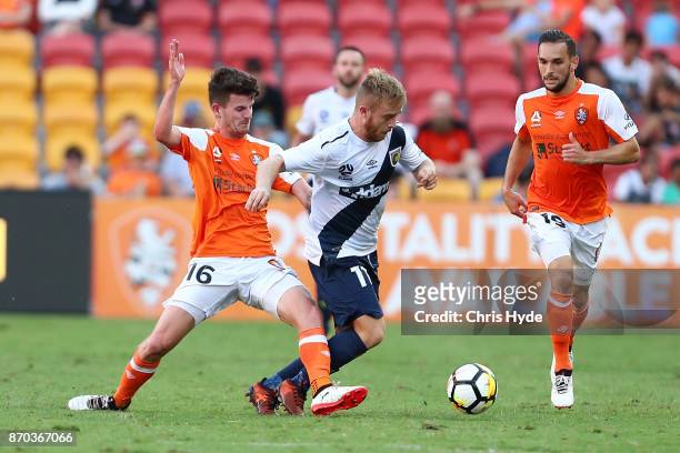 Mitchell Oxborrow of the Roar and Connor Pain of the Glory compete for the ball during the round five A-League match between the Brisbane Roar and...