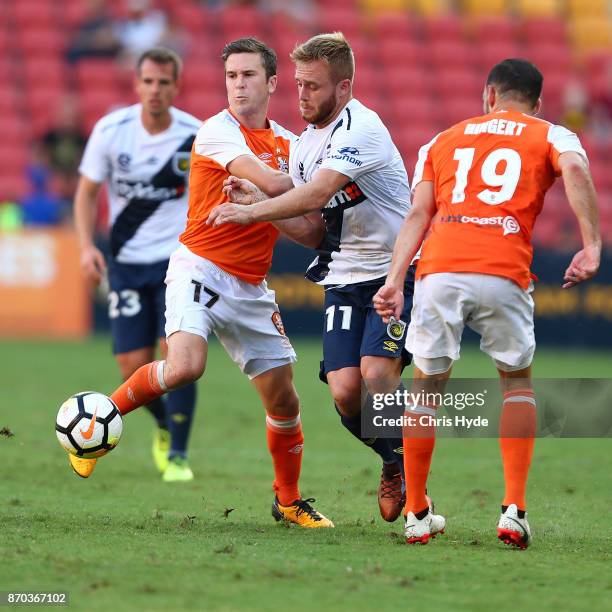 Matthew McKay of the Roar and Connor Pain of the Glory compete for the ball during the round five A-League match between the Brisbane Roar and the...