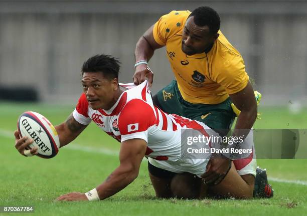 Lemano Lava Lemeki of Japan is held by Tevita Kuridrani during the rugby union international match between Japan and Australia Wallabies at Nissan...