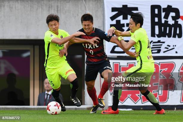 Yuma Suzuki of Kashima Antlers controls the ball under pressure of Kazuki Nagasawa and Ryota Moriwaki of Urawa Red Diamonds during the J.League J1...