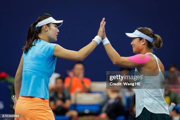 Yingying Duan and Xinyun Han of China celebrate in the doubles final against Jingjing Lu and Shuai Zhang of China during the WTA Elite Trophy Zhuhai...