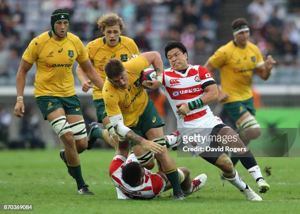 Sean McMahon of Australia is tackled during the rugby union international match between Japan and Australia Wallabies at Nissan Stadium on November...