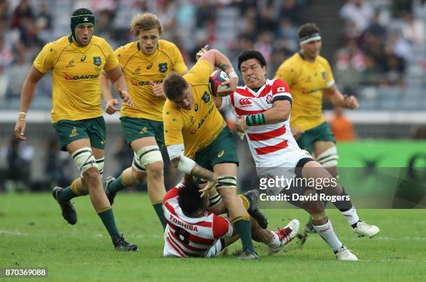 Sean McMahon of Australia is tackled during the rugby union international match between Japan and Australia Wallabies at Nissan Stadium on November...