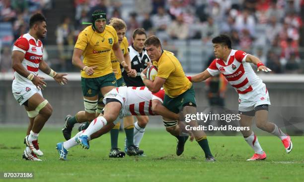 Sean McMahon of Australia is tackled during the rugby union international match between Japan and Australia Wallabies at Nissan Stadium on November...