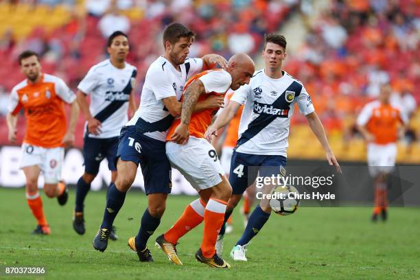 Liam Rose of the Mariners and Massimo Maccarone of the Roar compete for the ball during the round five A-League match between the Brisbane Roar and...