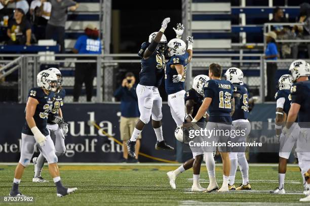 Defensive lineman Jermaine Sheriff and defensive lineman John Broome jump in celebration of a goal-line stand that prevented UTSA from tying the game...
