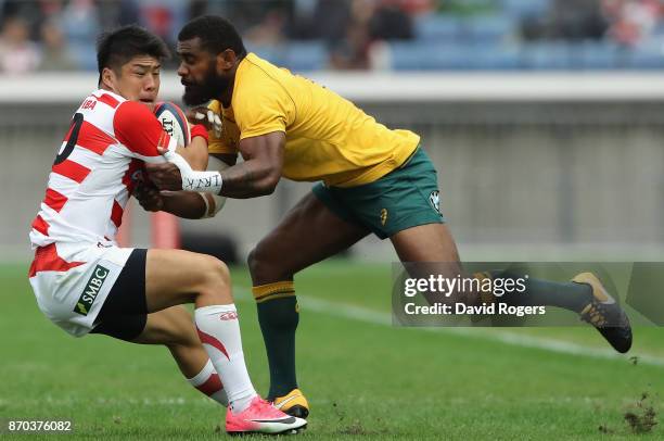 Rikiya Matsuda of Japan is tackled by Marika Koroibete during the rugby union international match between Japan and Australia Wallabies at Nissan...