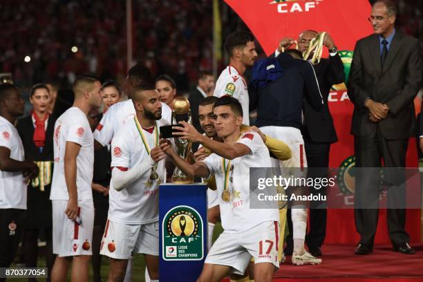 Players of Wydad Casablanca pose for a team photo with the trophy after winning 1-0 in the CAF African Champions League match against Al Ahly at the...